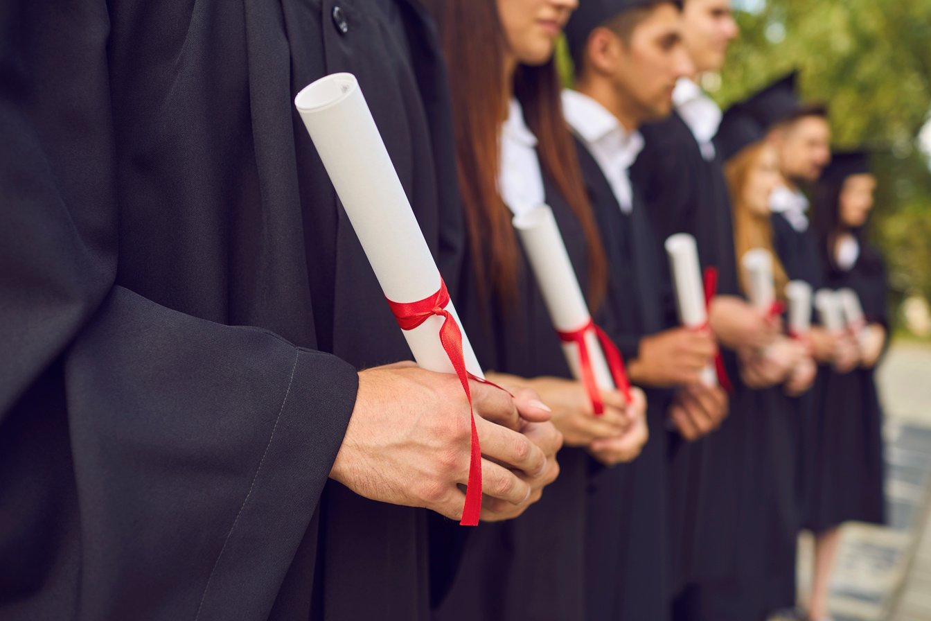 University Graduates Hands Holding Diplomas after University Graduating